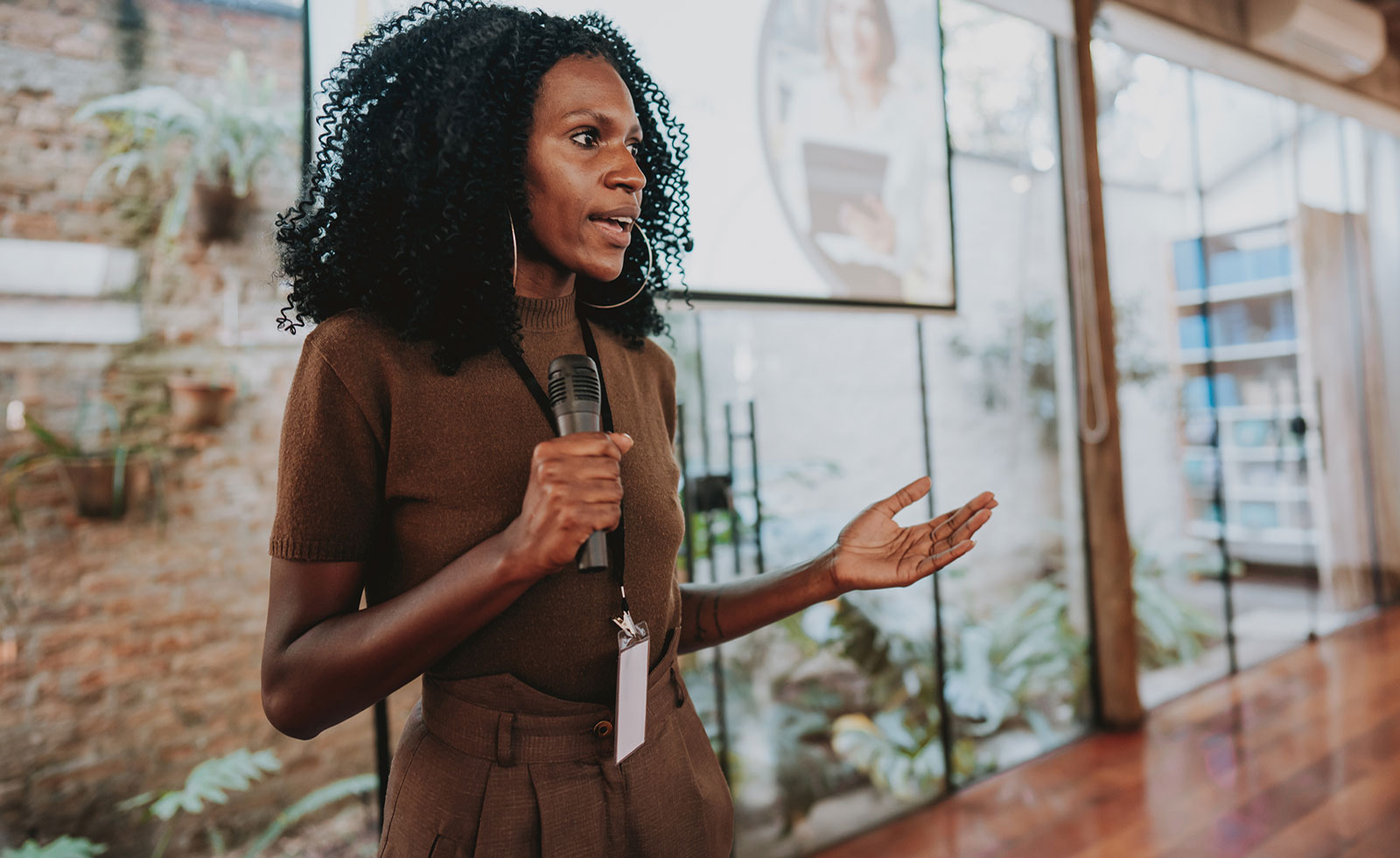 Black female lecturer delivering a presentation.