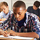 Classroom of diverse high school students seated at desks.