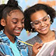 Two middle school girls examine science experiment results together.