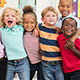 Diverse group of elementary school children pose for photo.