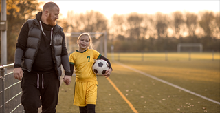 Father walking and holding daughter's hand