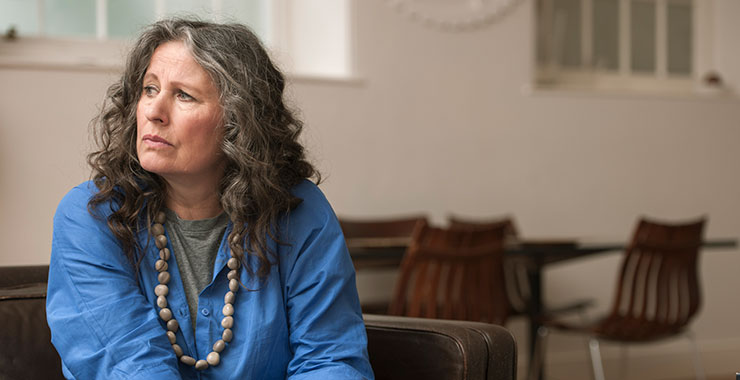 worried woman looking toward a window