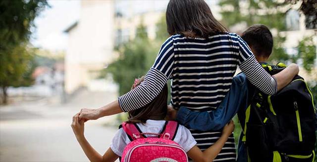 mother taking kids to school