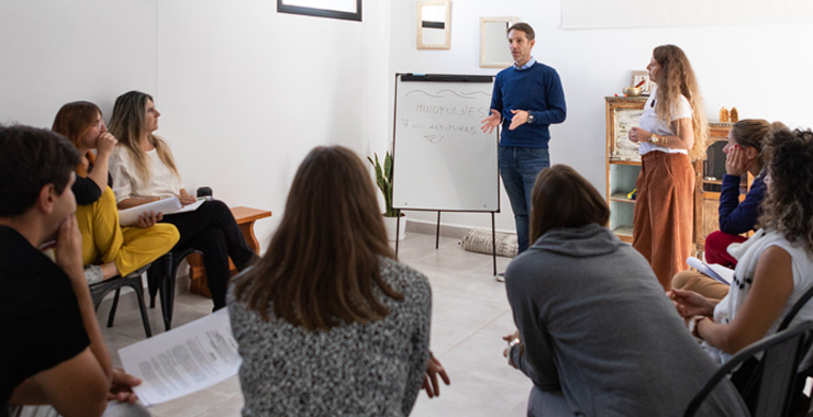 person presenting in front of a small group of people