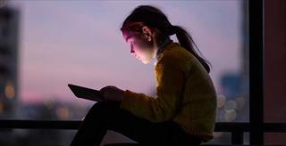 tween girl looking at tablet computer