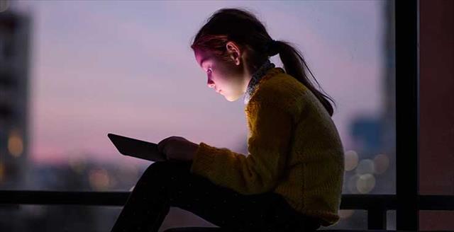 tween girl looking at tablet computer