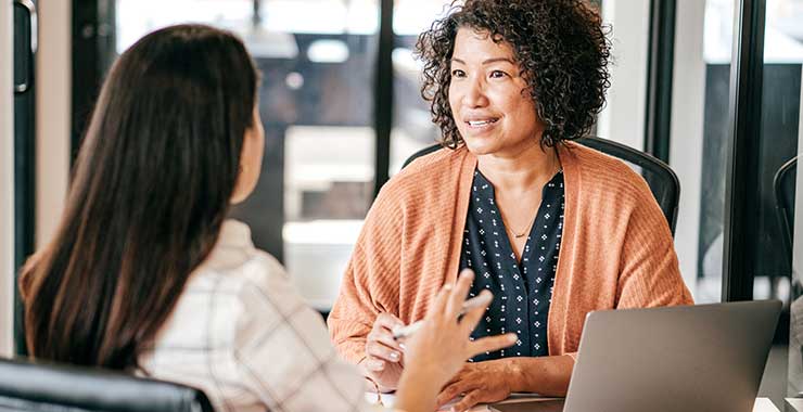 Two women having a discussion in an office